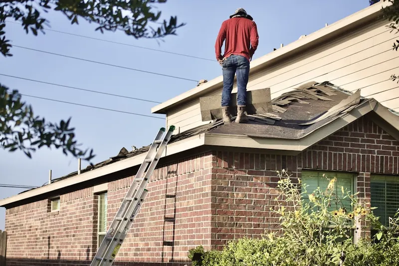 Professional roofer working on a residential roof in Club